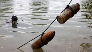 a-diver-from-a-bomb-disposal-unit-looks-at-unexploded-shells-recovered-in-meuse-river-at-sivry-sur-meuse--close-to-ww1-battlefields-7